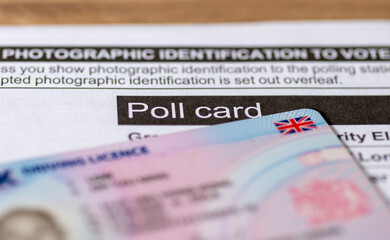 An official poll card for government elections and a UK photo driving licence as prove of identity. - obrazy, fototapety, plakaty