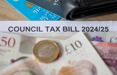 Macro close up of a UK Council Tax bill with bank notes, Pound coin, bank cards and a purse. - obrazy, fototapety, plakaty