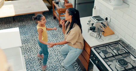 Mother, child and happy dance in kitchen with energy, fun and bonding for quality time together...