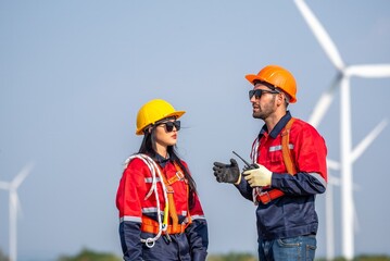 couple engineer team inspection check control wind power machine construction installation in wind energy factory. Two technician professional worker discussion for maintenance wind power turbine