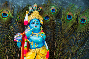 Lord Krishna sculpture isolated on Peacocks feather or Mayil‍ppeeli