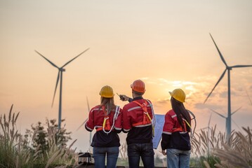 engineer technician team raise joy hand for success happiness at wind power plant machine ....