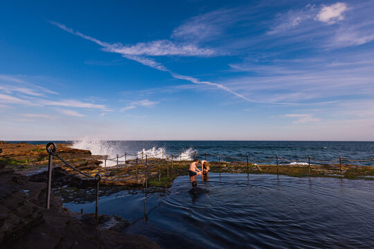 Children swimming in the Bogey Hole, historic man-made rock pool in Newcastle NSW