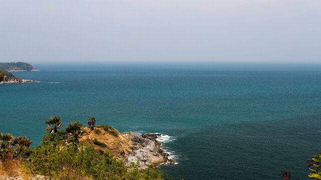 Landscape image of the beautiful Phromthep Cape in Phuket, Thailand with deep blue waters.