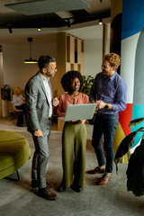 Creative team engaging in a lively brainstorming session at a colorful office space