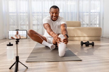 Man stretching on yoga mat during workout