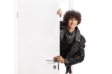 Guy in a black leather jacket standing behind a door