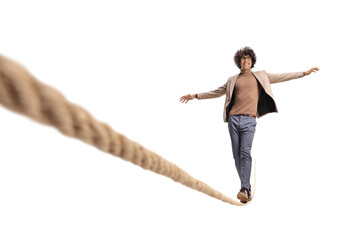 Excited young man with curly hair walking on a tightrope and smiling