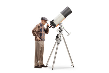 Elderly man observing the sky with a telescope