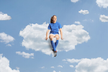 Teenage girl in a football jersey floating on a cloud