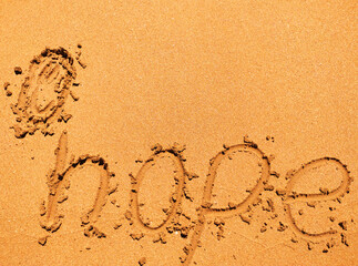 Hope written on the sand beach. 

