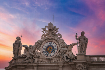 Stunning view of ornate clock and sculptures against twilight sky at the Vatican. Features Roman...