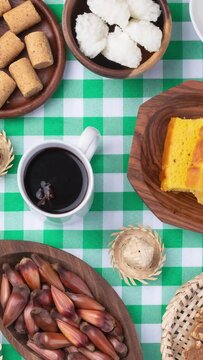 Vertical video. Typical brazilian june festival food over plaid fabric. Festa junina