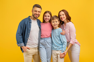 Happy family with two kids posing together