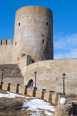 The Long-neck tower of the ancient Ivangorod fortress on a sunny March day. Leningrad region, Russia - 779929771