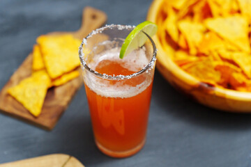 Michelada, Mexican alcoholic cocktail with beer, lime juice, tomato juice