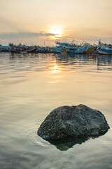 Sunrise at the fishing harbor with fishing boats parked