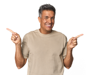 Middle-aged Latino man pointing to different copy spaces, choosing one of them, showing with finger.