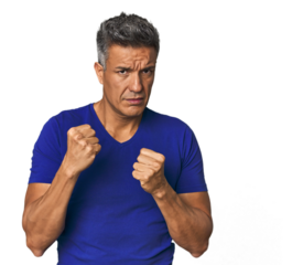 Middle-aged Latino man throwing a punch, anger, fighting due to an argument, boxing.