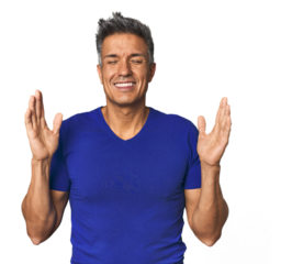 Middle-aged Latino man joyful laughing a lot. Happiness concept.