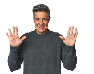 Middle-aged Latino man showing number ten with hands.