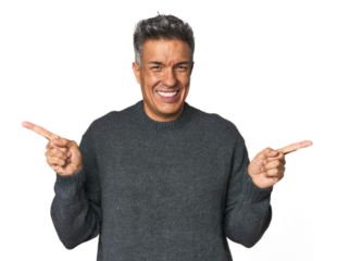 Middle-aged Latino man pointing to different copy spaces, choosing one of them, showing with finger.