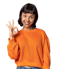 Young Hispanic woman with short black hair in studio cheerful and confident showing ok gesture.