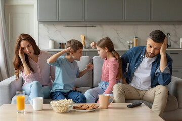 Sibling quarrel with parents feeling stressed, home interior - obrazy, fototapety, plakaty