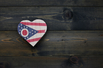 wooden heart with national flag of ohio state on the wooden background.