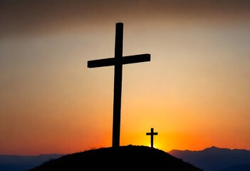 A large cross on top of a hill with the sun setting behind mountains
