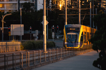 The G:link light rail tram on the Gold Coast passing through station with Surfers Paradise buildings