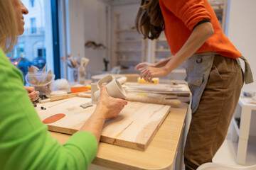 Senior Woman and Companion Crafting Ceramics Together