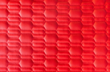 Naklejka premium red leather background and texture as a pattern for the interior car or a sofa or wall covering