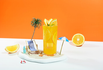 Squeezed orange juice garnished with orange slice isolated on studio background. summertime summer drink concept.