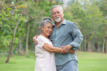 senior couple in love, embracing and hugging each other in the park
