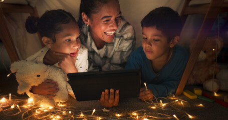 Funny, tablet and mother with children in a tent house streaming internet video, show or movie online in the night. Dark, digital and parent or dad relax with kids watching comedy in the evening - obrazy, fototapety, plakaty