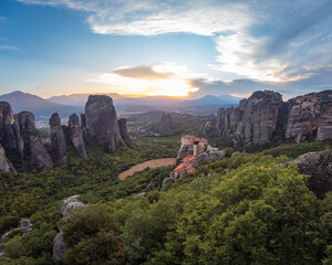 Fototapeta na wymiar High aerial drone view of Holy Monastery of Rousanou (Saint Barbara) in Meteora, Greece at sunset. Holy Monastery of Roussanou (Rousanos), a UNESCO World Heritage site in the evening.