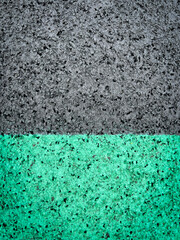 Track and Field Surface Close-Up. Overhead views of a textured rubber surface of a running track. Color blocks of black and green. Closeup surface views.
