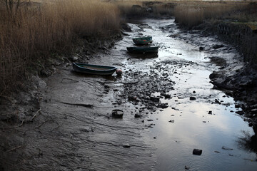 Evening light on Tay river bank - boats on mud - River Tay - Perthshire - Scotland - UK