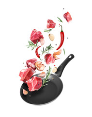 Raw beef meat steaks with garlic and rosemary are falling into a frying pan isolated on white...