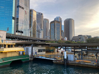 City harbor with ferries waiting on the dock. Sydney skyscrapers on the waterfront. City skyline,...