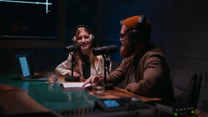 Two young stylish radio show hosts record fresh podcast episode in home loft studio apartment