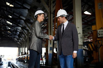 businesspeople shaking hands before start work at construction site