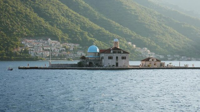 Church of Our Lady of the Rocks, located on a small island in the Bay of Kotor near the city of Perast. Video from the boat. 
