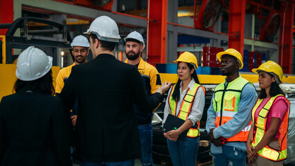 Obraz premium Team engineers and foreman stack hand and shake hands to show success at factory machines. Worker industry join hand for collaboration..