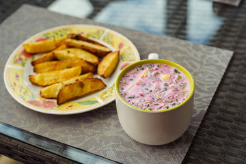 Cold Lithuanian soup Šaltībarščiai, a cold summer soup made of beetroot and kefir, popular in Lithuania, Latvia, Poland and Belarus, served with baked potatoes