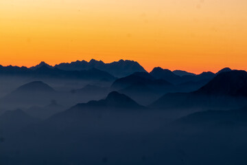 Panoramic sunrise view from Dobratsch on the Julian Alps and Karawanks in Austria, Europe....