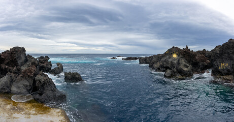 Stunning natural pools of Biscoitos, Terceira Island, Azores, nestled amidst black volcanic rocks formed by eruptions.