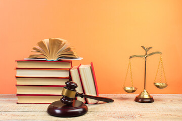 Law concept - Open law book, Judge's gavel, scales, Themis statue on table in a courtroom or law enforcement office.