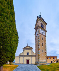 Facade of Sant'Abbondio Chuch with high bell tower, Collina d'Oro, Switzerland